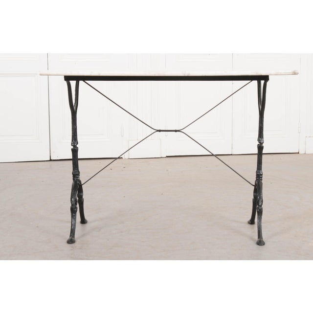 A charming French marble-top bistro table with a black-painted iron base, c.1910. The white marble top is in wonderful...