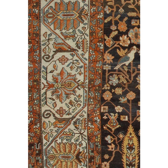 An early 20th-century beautiful brown Persian Bakhtiari Oversized rug with a small snake found