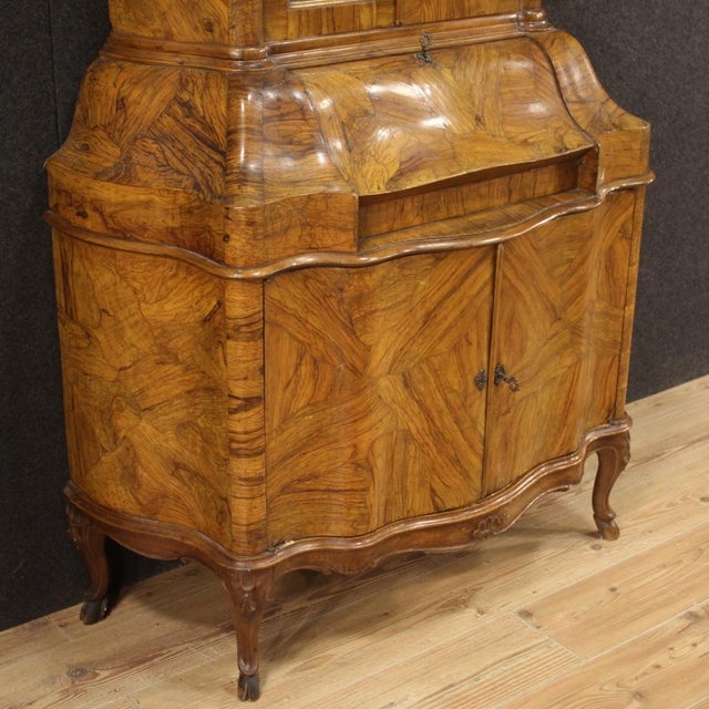 Venetian trumeau from the mid-20th century. Double body furniture carved and veneered in walnut, olive, burl and beech...