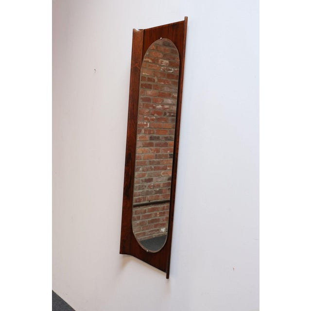 Sculptural mirror designed by Donati for Stil Glass (ca. 1960s, Italy). Composed of an inset ellipse/oval mirror glass...