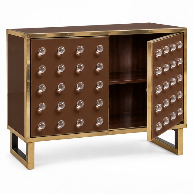 Warm chocolate brown surrounds a grid of clear Murano glass spheres in this Italian drinks cabinet. Forty spheres animate...