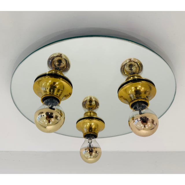 A wonderful 1960s Two-tone, gold and silver mirror flush mounted light with brass fittings. Rewired. Three candelabra...