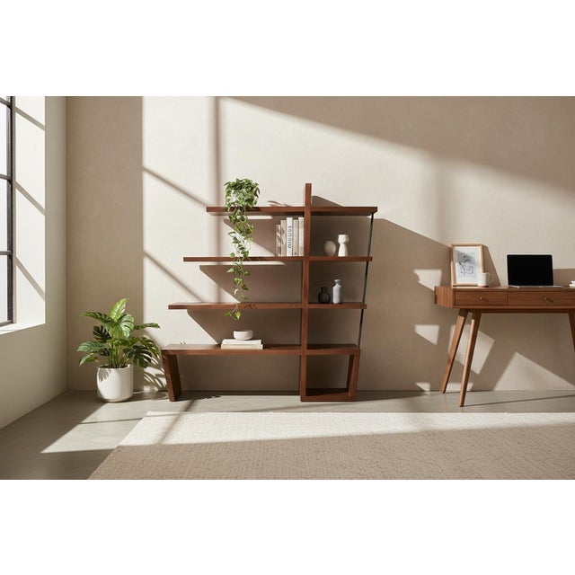 An original walnut bookcase attributed to William Emmerson, designed with a clean, open shelving structure that balances...