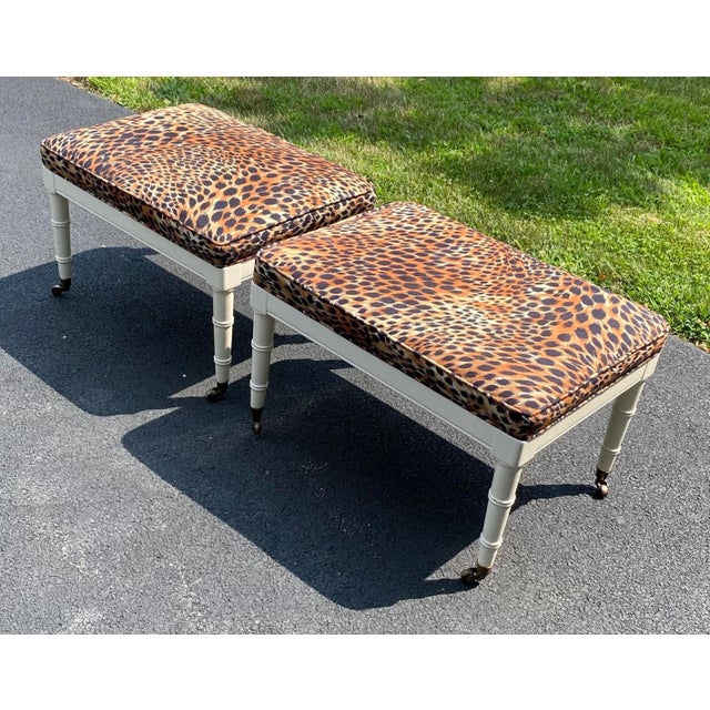Pair of beautiful vintage leopard microsuede ottoman benches. The cream ottomans have tapered turned legs and brass...