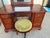 This vanity with swinging mirror and stool comes from the mid 20th century. It is a mahogany chippendale style vanity....