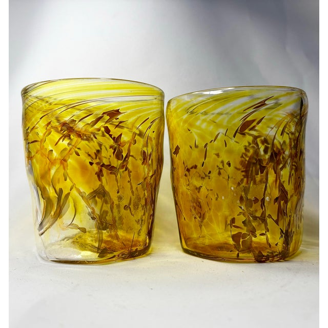 A wonderfully expressive pair of vintage Venetian Murano art glass drinking tumblers, featuring luminous golden-yellow and...