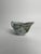 This Chinese export porcelain sauce boat, decorated with green floral motifs, is a fine example of the elegant and highly...