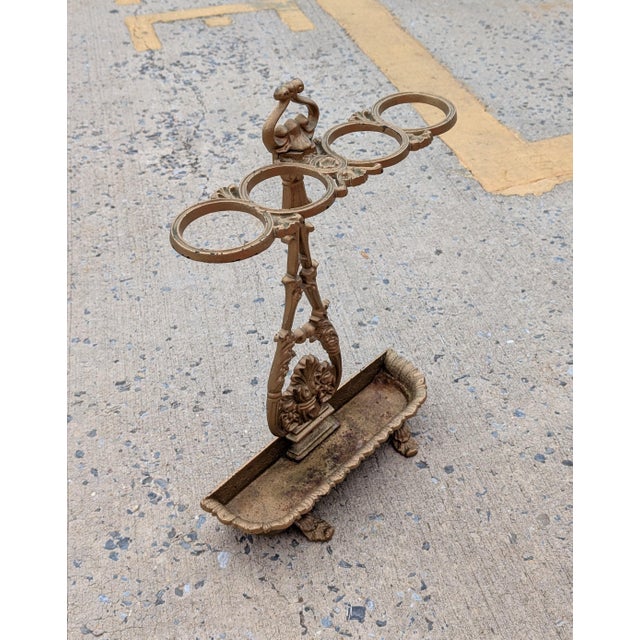 Add vintage architectural elegance to your entryway with this authentic 19th-century cast iron umbrella stand, featuring a...