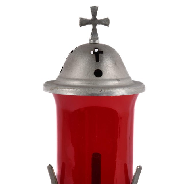 This antique candle‑based sanctuary lamp features a striking ruby red glass cylinder housed in a decorative metal frame...