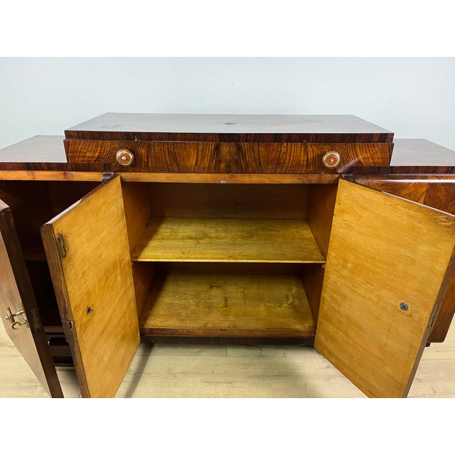 Sideboard with a drawer and four doors in burl wood with aluminum details and Bakelite handles, made in Italy in the...