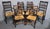 A super set of eight harlequin country elm kitchen dining chairs, including two carvers, rush seats in very good condition\.