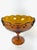 Beautiful vintage amber carnival glass pedestal bowl. This piece features a scalloped with tear drop accents along the...
