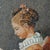A lovely and exotic rendering of Fragonard's famous depiction of a young girl engrossed in her book. The gemstones glisten...