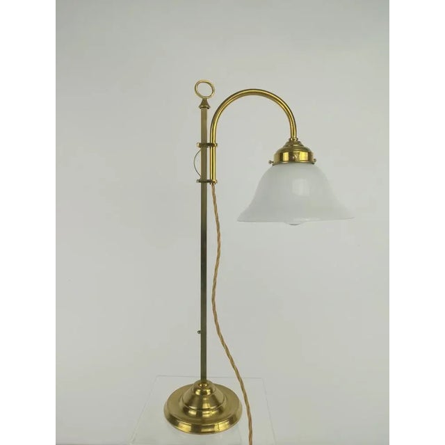 Women's desk lamp with bound -blown over -catch glass. Height adjustable through extraordinary clamping mechanism The lamp...