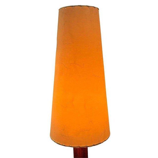 The Nickel Básica M2 table lamp by Santiago Roqueta for Santa & Cole with cone shade. It features a mahogany wood cylinder...