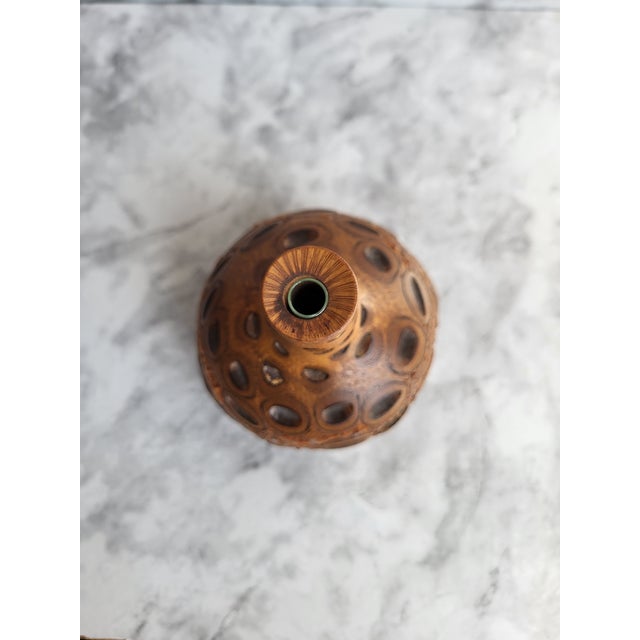 This is a hand-turned bud vase crafted from and Australian Banksia seed pod. It features a distict textured surface with...