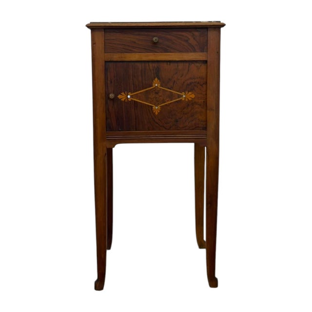 This vintage-style wooden accent table features an inset mottled brown marble top, a single top drawer with a brass pull,...