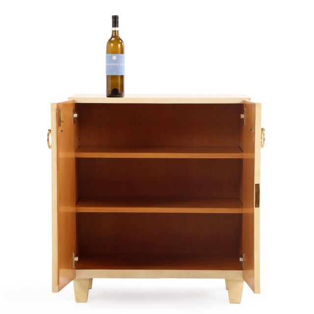 A refined example of mid-century modern cabinetry, fully wrapped in natural parchment with a soft, matte sheen that subtly...