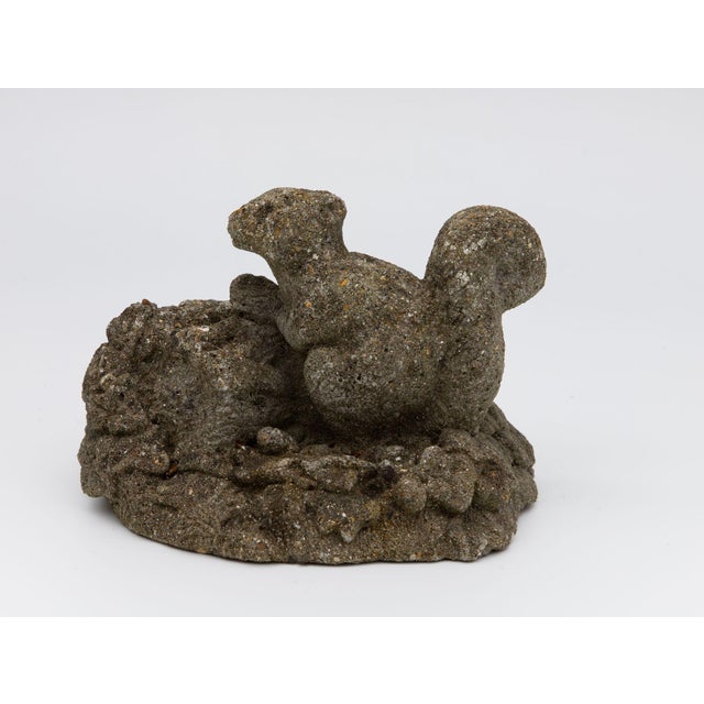 This remarkable mid-20th century English garden ornament captures the essence of a quiet moment of a squirrel in a garden....