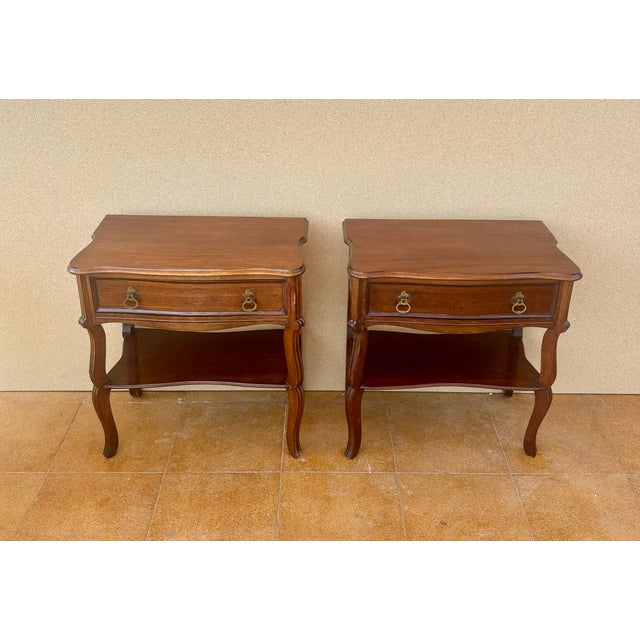 Charming pair of Spanish bedside tables dating from the mid-20th century. Crafted in wood, each table features a spacious...