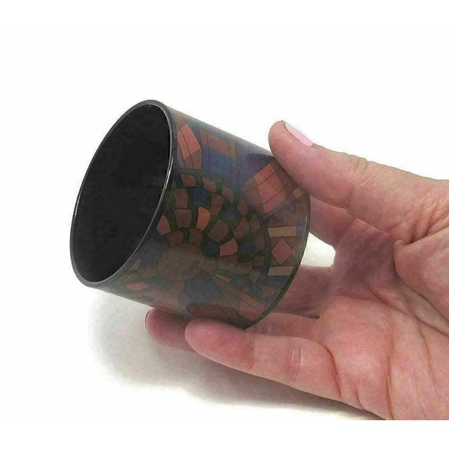 This stunning Hermès extra-wide enamel bangle bracelet features a striking abstract, mosaic-style design, making it a...