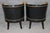 This striking pair of French Directoire or Regency-style armchairs combines a dramatic ebonized finish with classical gilt...