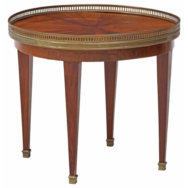 Elegant French Neoclassical–style side table crafted in the early 20th century. The round top features beautifully...