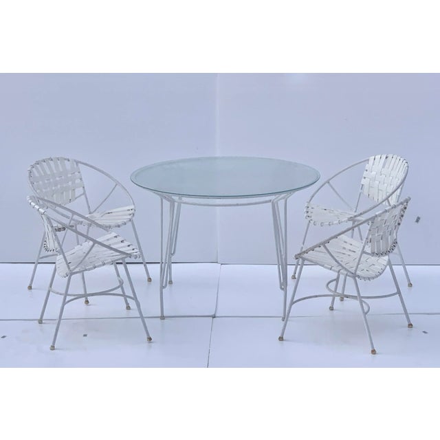 Beautiful 1960s Mid-Century Modern wrought iron patio set. This set of 4 chairs and table have amazing wrought iron frame,...