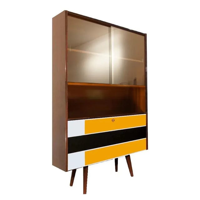 Bookcase with a lockable bar, 1970s In the upperside the glasscase with sliding glass doors Contemporary manual painting...