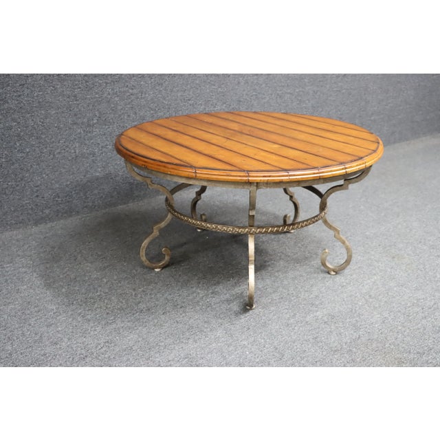 Century furniture coffee table with distressed Cherry top and forged iron base.
