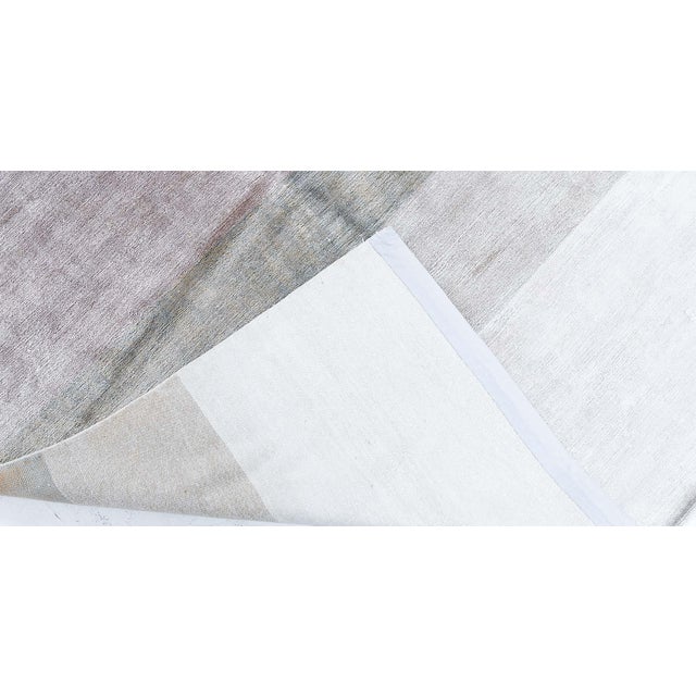 Refined in its simplicity, this modern hand-knotted silk rug offers a sophisticated and serene presence, perfect for...