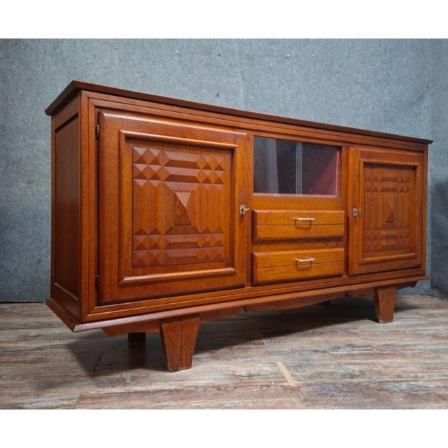 Art deco style carved oak sideboard, circa 1930. this piece is distinguished by its elegant horizontal lines and fine...