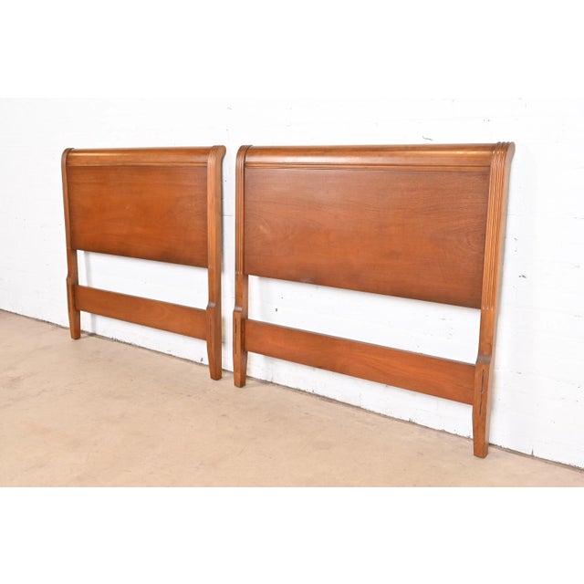 A gorgeous pair of Regency or Sheraton style carved mahogany twin size headboards By Drexel USA, 1950s Each measures:...