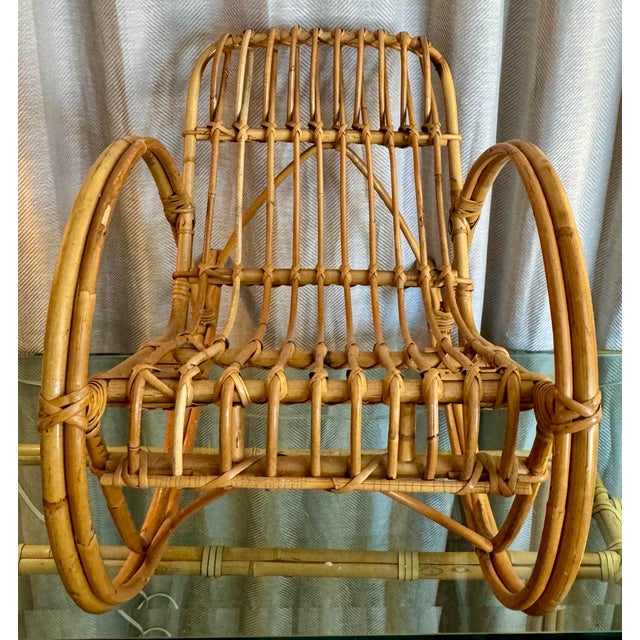 Rare, vintage child size Franco Albini-style natural bamboo two-strand round arm stick rattan rocking chair featuring...