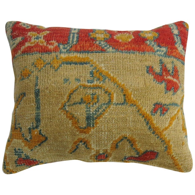 Pillow made from an early 20th century coral tan color antique Oushak rug. Measures: 16" x 20".
