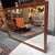 Design Plus Gallery presents a Vintage Rosewood Framed Wall Mirror. The rectangular mirror is bordered by a solid rosewood...