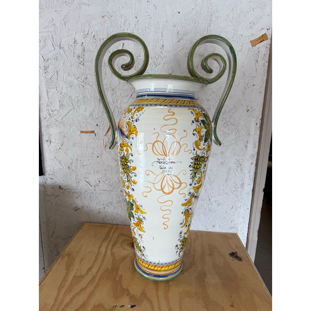 A hand-painted large ceramic Tuscan urn in the Italian Renaissance style, having a Medici crest on the front and with...