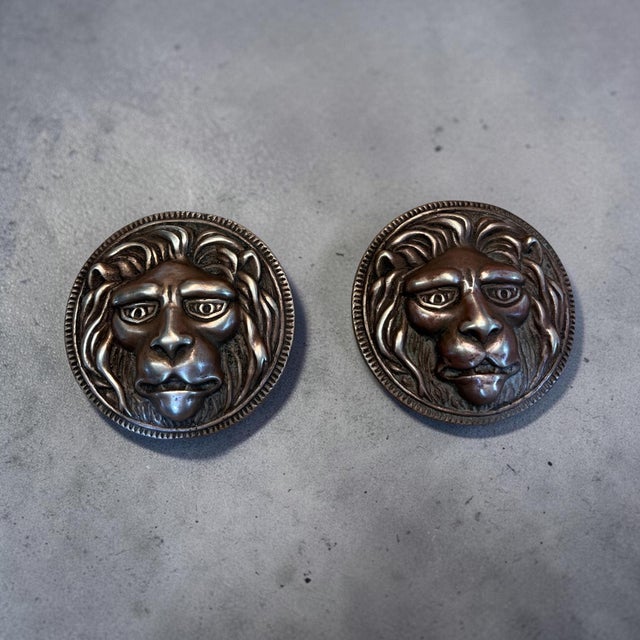 Handsome pair of vintage cast bronze lion head paperweights featuring highly detailed sculptural faces surrounded by full,...