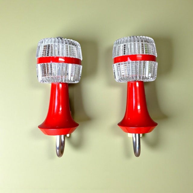 Striking pair of vintage Space Age wall sconces, most likely dating from the 1960s–1970s, with a playful combination of...