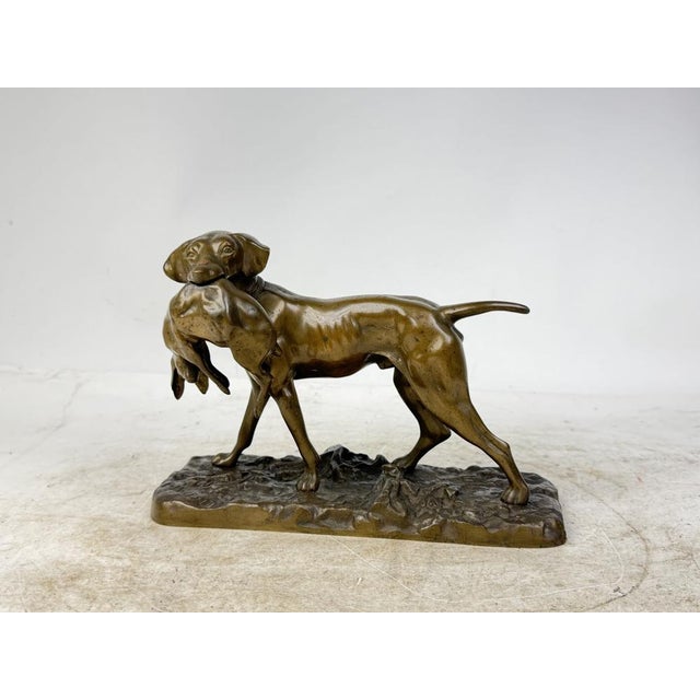 Beautiful bronze sculpture depicting a hunting dog with a hare in its jaws. A great decorative piece and collector's item.