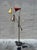 A sculptural multi-arm floor lamp featuring articulating cone shades, balanced metal arms, and playful color blocking...