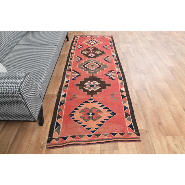 Vintage Hand-Knotted runner rug is a semi-antique vintage area rug. The '70s Eastern region of Anatolia's unique rug is...