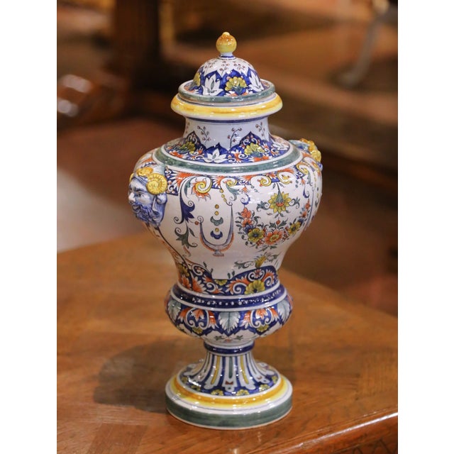 Decorate a console or mantel with this colorful antique faience urn. Crafted in France circa 1880, the covered vessel is...