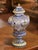 Decorate a console or mantel with this colorful antique faience urn. Crafted in France circa 1880, the covered vessel is...
