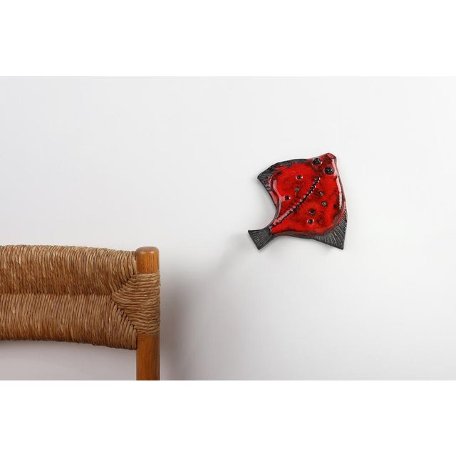A playful yet finely crafted example of Belgian mid‑century ceramic art, this 1960 sculptural fish. Created by the...