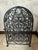 This vintage wrought‑iron wine rack features beautifully curved scrollwork, circular bottle cradles, and a decorative...