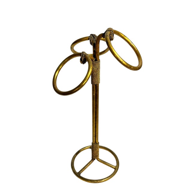 A sculptural vintage Italian gold tile towel stand featuring an elegant looping ring design with beautifully aged patina...