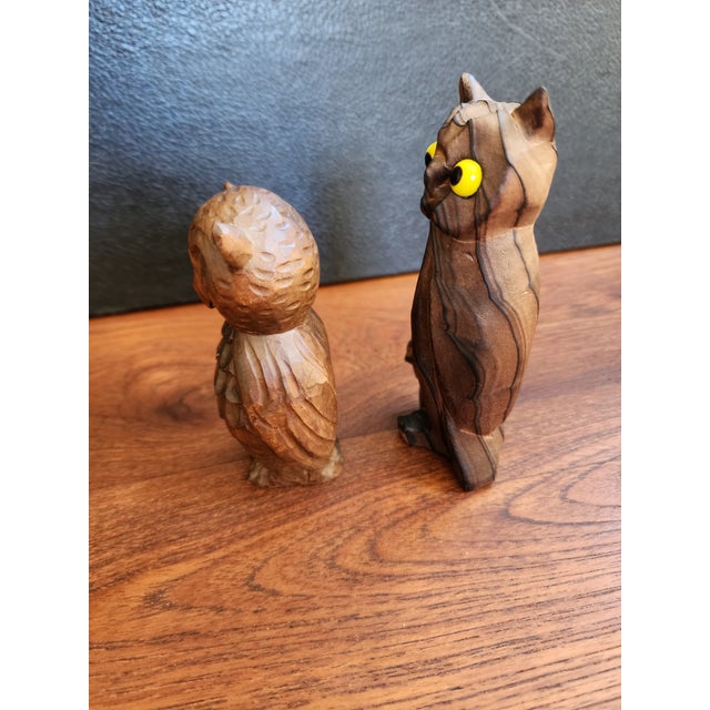A cute pair of hand carved wooden owls. One with a baby owl at its feet, has glass eyes, made in Japan and the other...