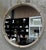 The Cyprus Round Mirror showcases a white faux shagreen leather wrap featuring brass-plated steel bands that help elevate...