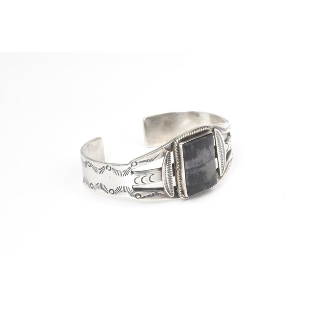 Fred Harvey Style Sterling Silver and Petrified Wood Cuff Bracelet A sterling silver cuff bracelet featuring a rectangular...